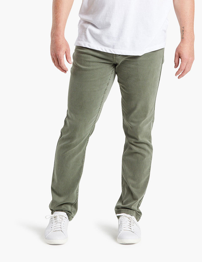 Model wearing army green Hydes jeans with white sneakers