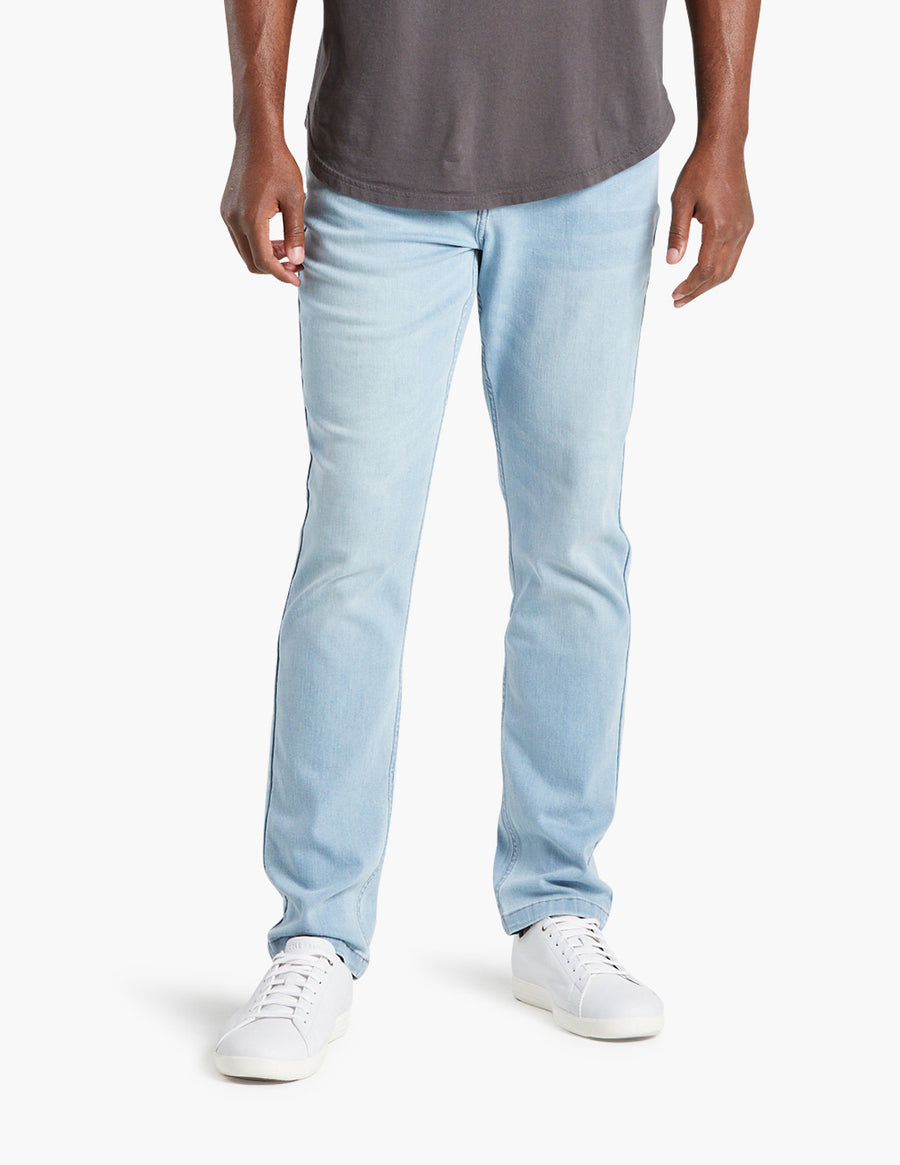 Model wearing lightwash Grands jeans with white sneakers