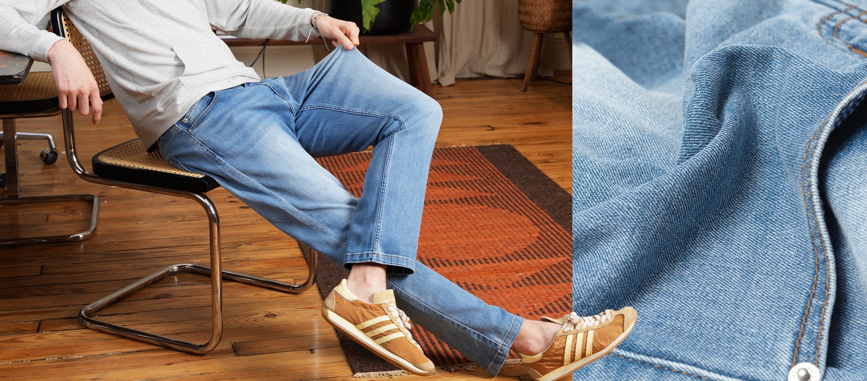 Seated side view of light-wash men’s jeans showing relaxed straight fit and soft stretch denim on a hardwood floor