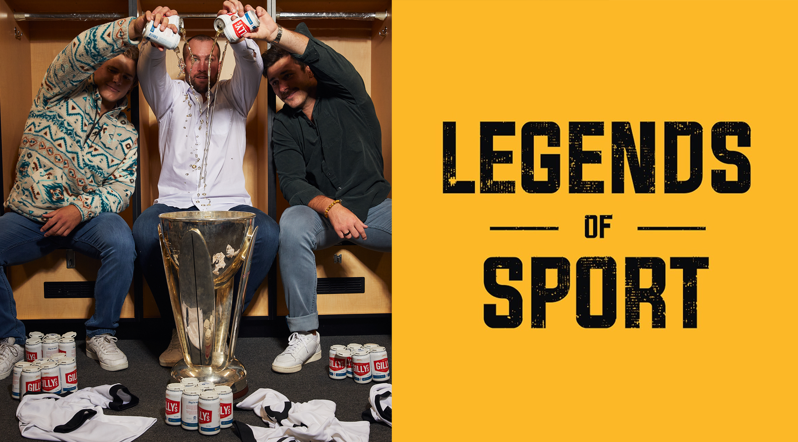 Three men in a locker room pouring beer into a large trophy; right panel reads LEGENDS OF SPORT; cans read GILLY'S.