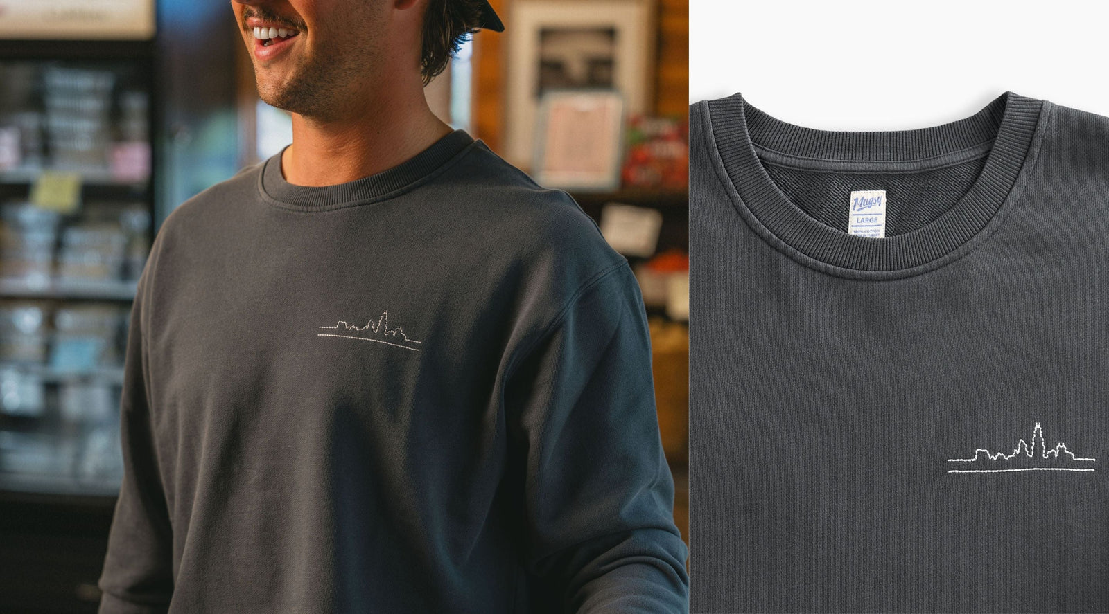 Charcoal crewneck with small white embroidered city skyline on left chest; collar tag reads Mugsy LARGE 100% COTTON