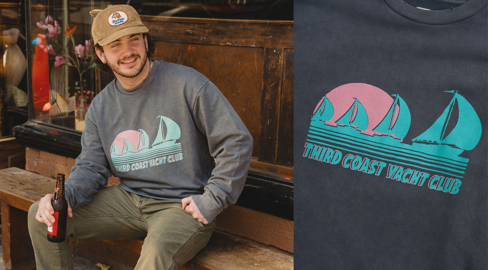 Man sitting on a bench wearing a gray sweatshirt with teal-pink sailboat graphic reading THIRD COAST YACHT CLUB.