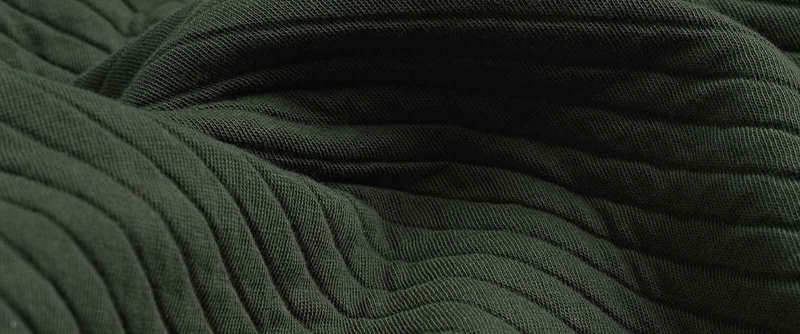 Close-up of Diamond Knit Shacket fabric showcasing dark green ribbed diamond knit texture with soft draped folds