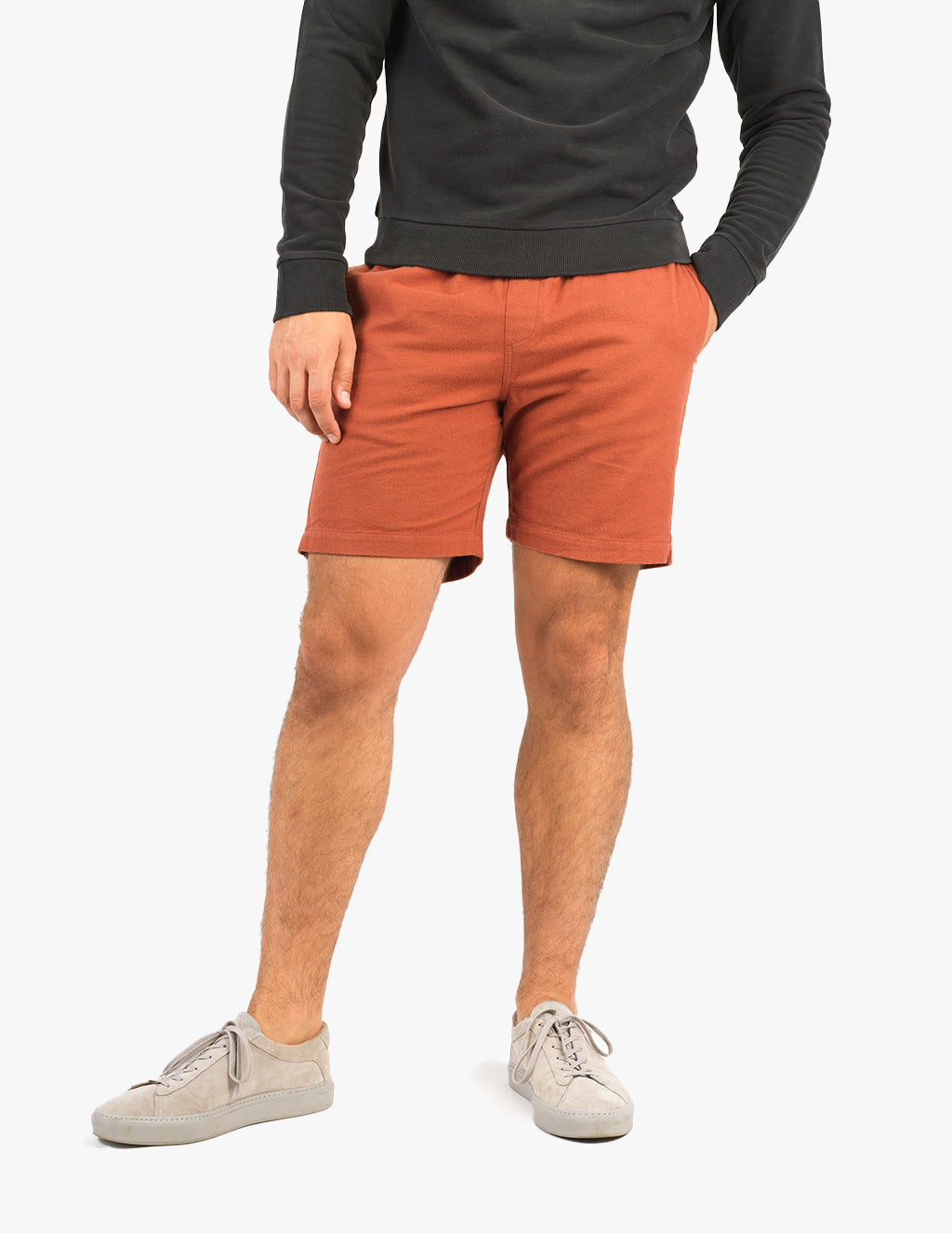 Model wearing Burnies shorts in burnt orange color