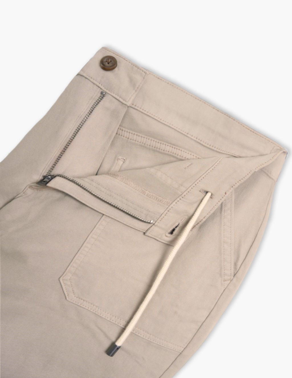 Beige/tan pants with open zipper fly, button closure, front pocket and long cream drawstring with metal tip.