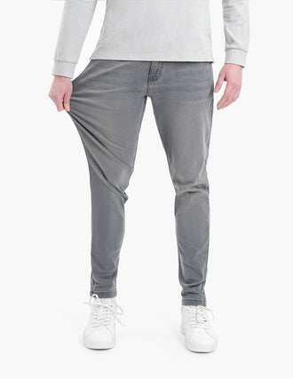 Model wearing Beans Tapered jeans in medium gray, showing flexibility and fit.