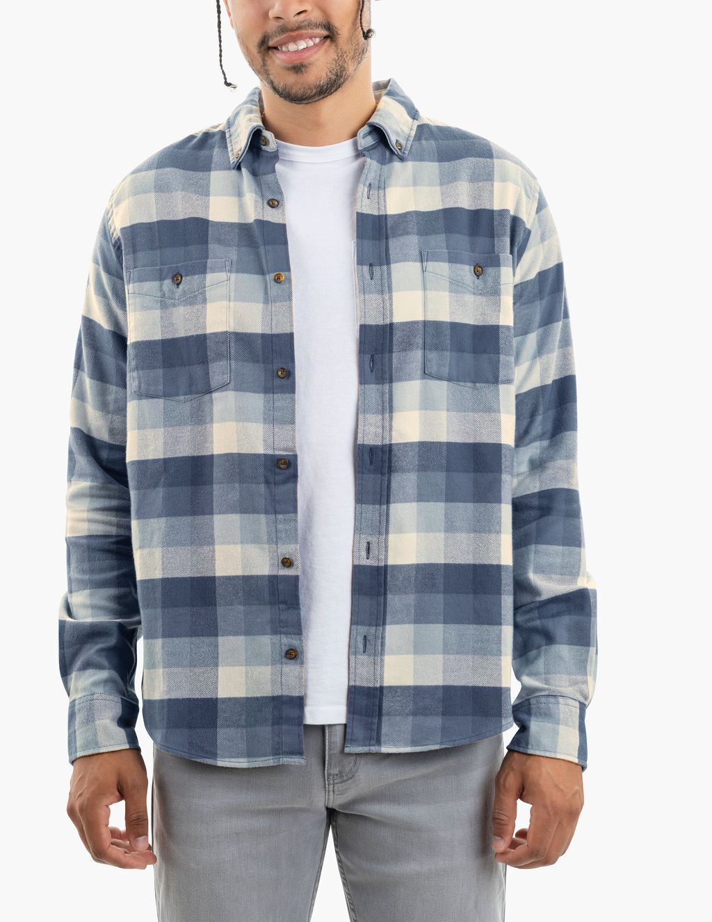 Man wearing blue-and-cream large-check flannel shirt over a white T-shirt and gray jeans, cropped at mid-face to thighs.