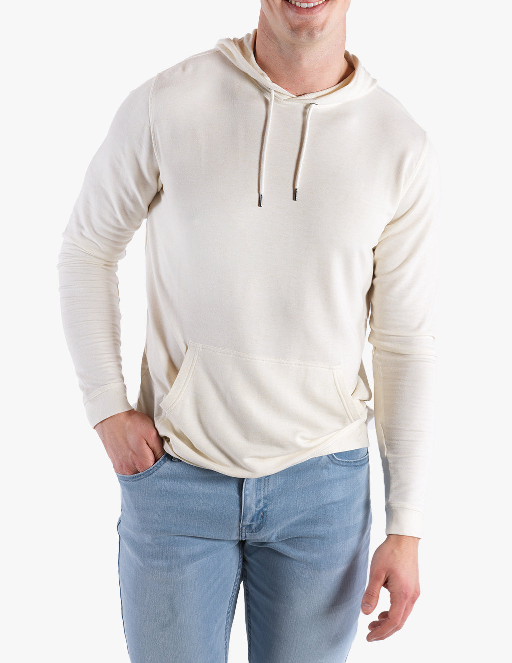 Model wearing a cashmere hoodie in oatmeal color, with jeans.