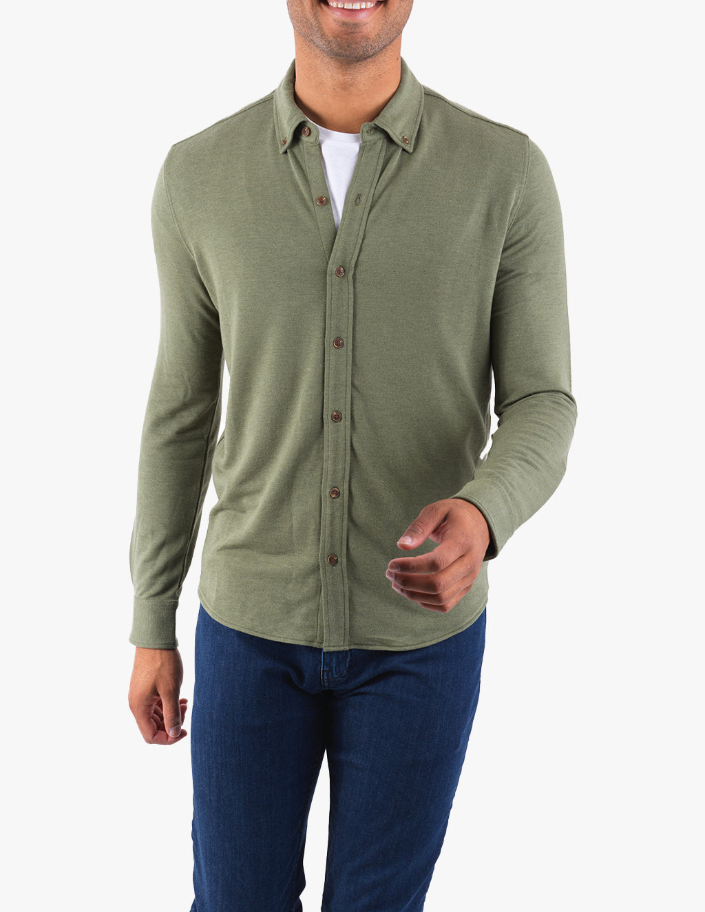 Model wearing a mossy green cashmere button-down shirt with a casual fit.