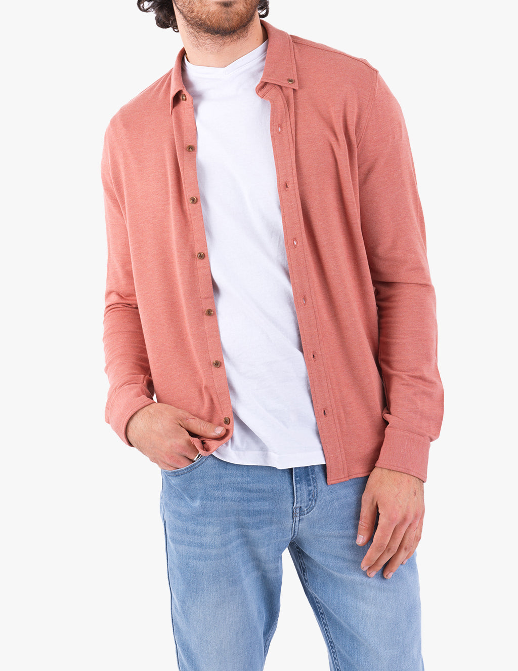 Model wearing a red cashmere button-down shirt over a white t-shirt with blue jeans.