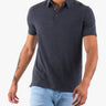 Men's dark heather short-sleeve polo on model with three-button placket and visible forearm tattoos