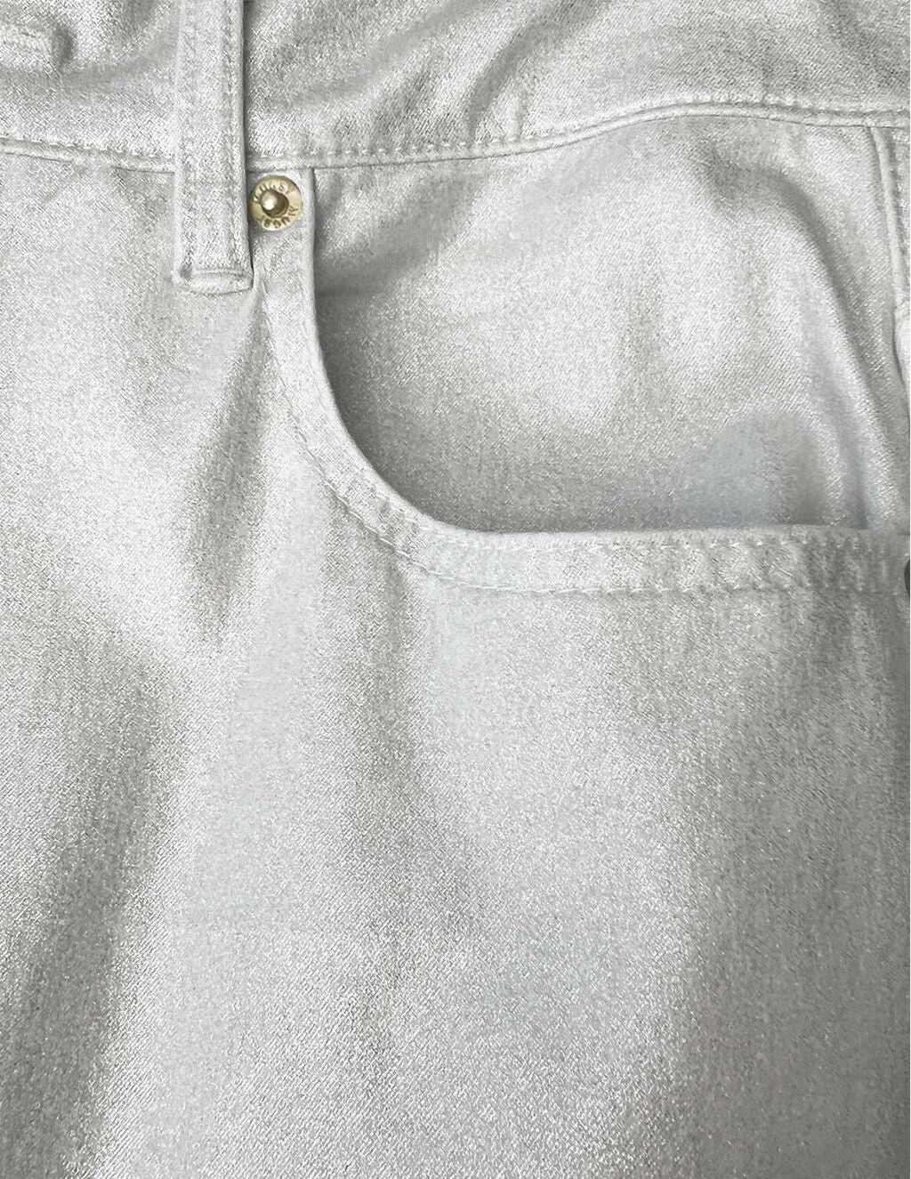 Champagne-colored denim front pocket with brass rivet and short belt loop.