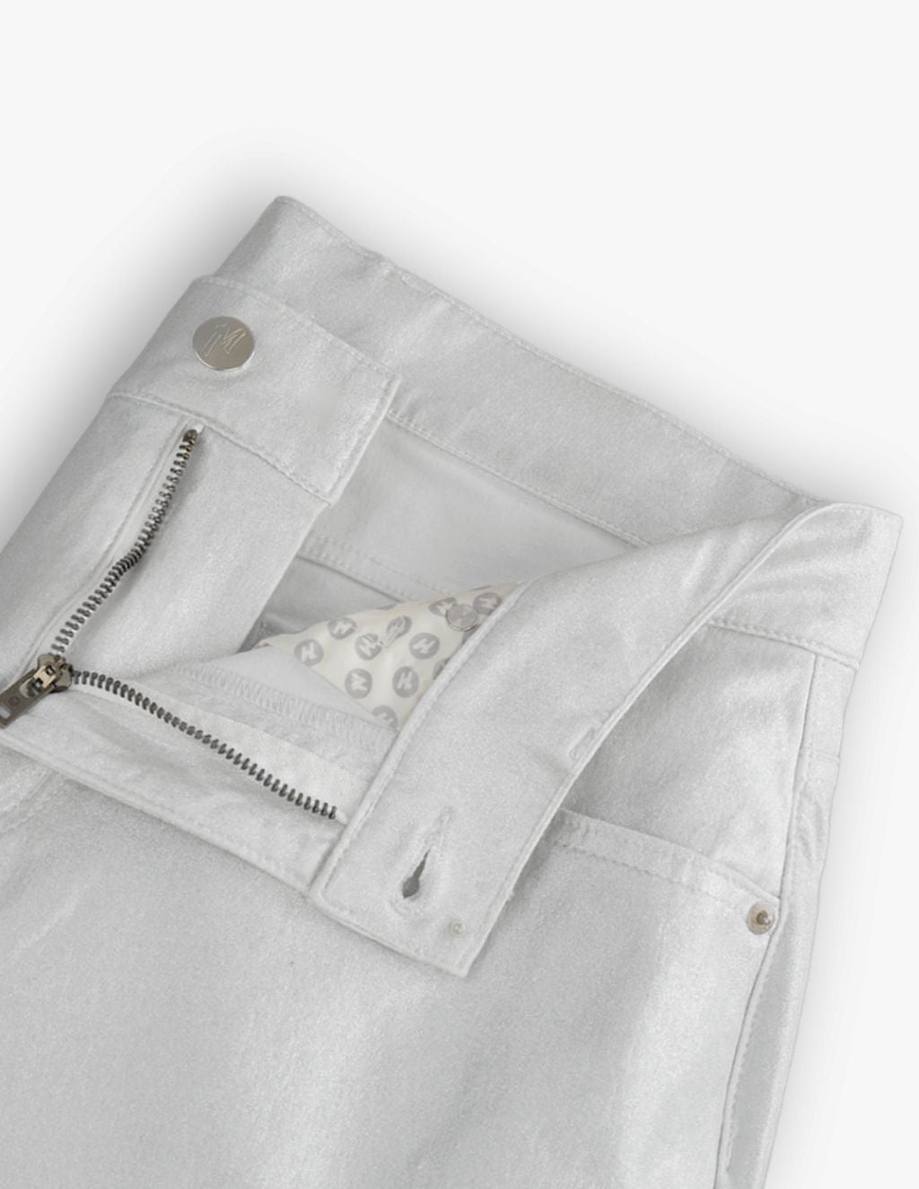 Light silver metallic jeans waistband with open zipper, button, and patterned pocket lining with repeating circular logos.
