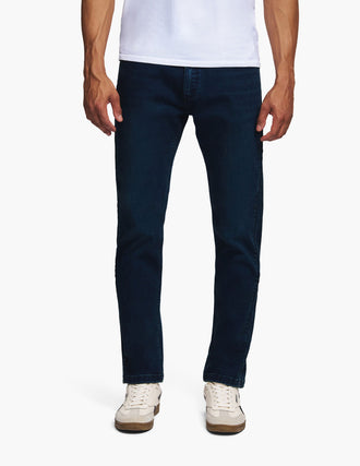 Front view of Dylans jeans showcasing dark indigo dyed color and slim fit on model with white background