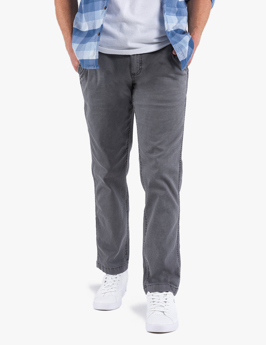 Model wearing Gravels canvas utility pants in gray, standing with hands in pockets.