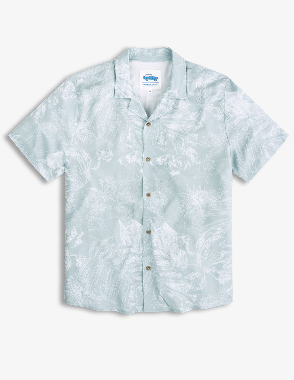 Light blue short-sleeve button-up shirt with white floral pattern, label inside collar reads 'DESIGNED IN CHICAGO' and 'MADE IN VIETNAM'.