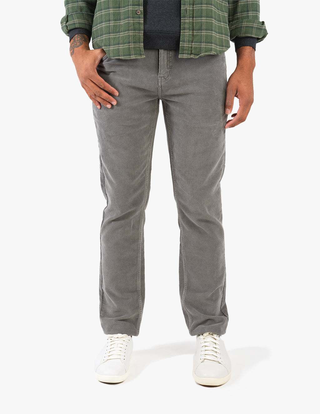Model wearing Matterhorns corduroy pants in gray with white shoes