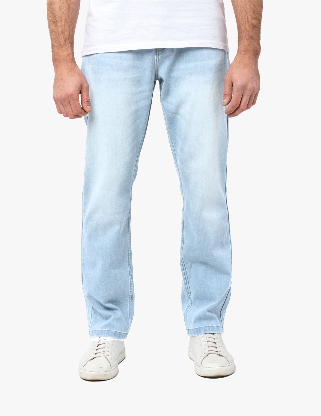 Light-wash straight-leg men's jeans shown on model from waist to shoes, paired with white low-top sneakers.