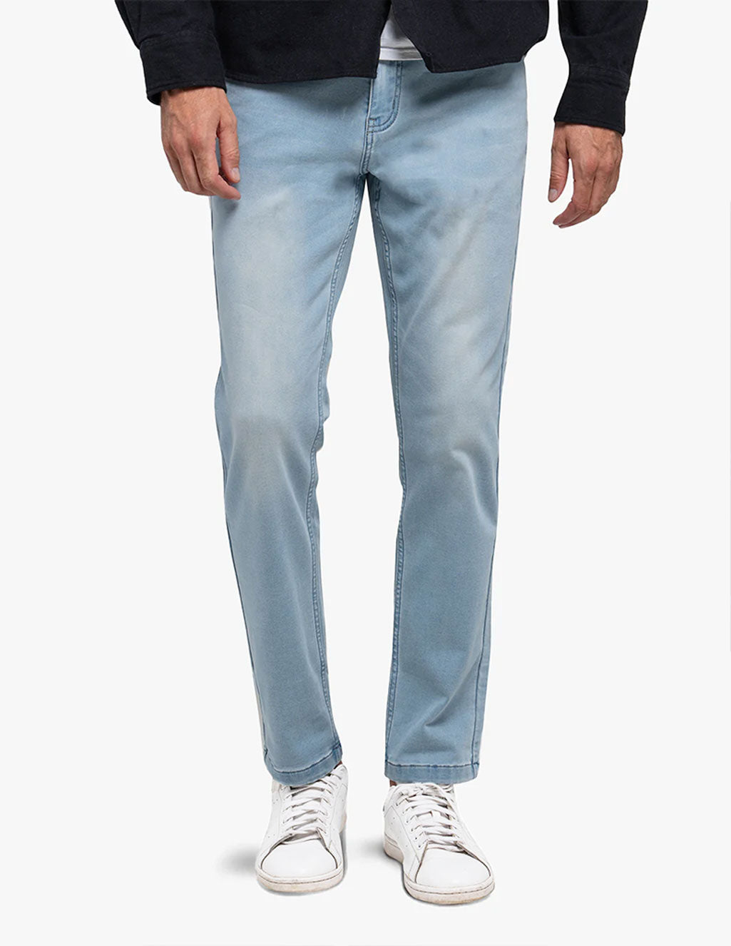 Light blue Grands Knit jeans worn by a person standing