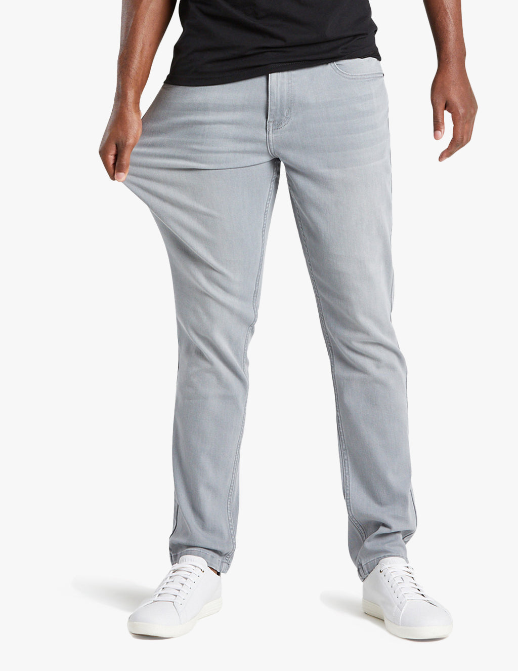 Model wearing light gray Johnnys jeans, showcasing flexibility and fit.