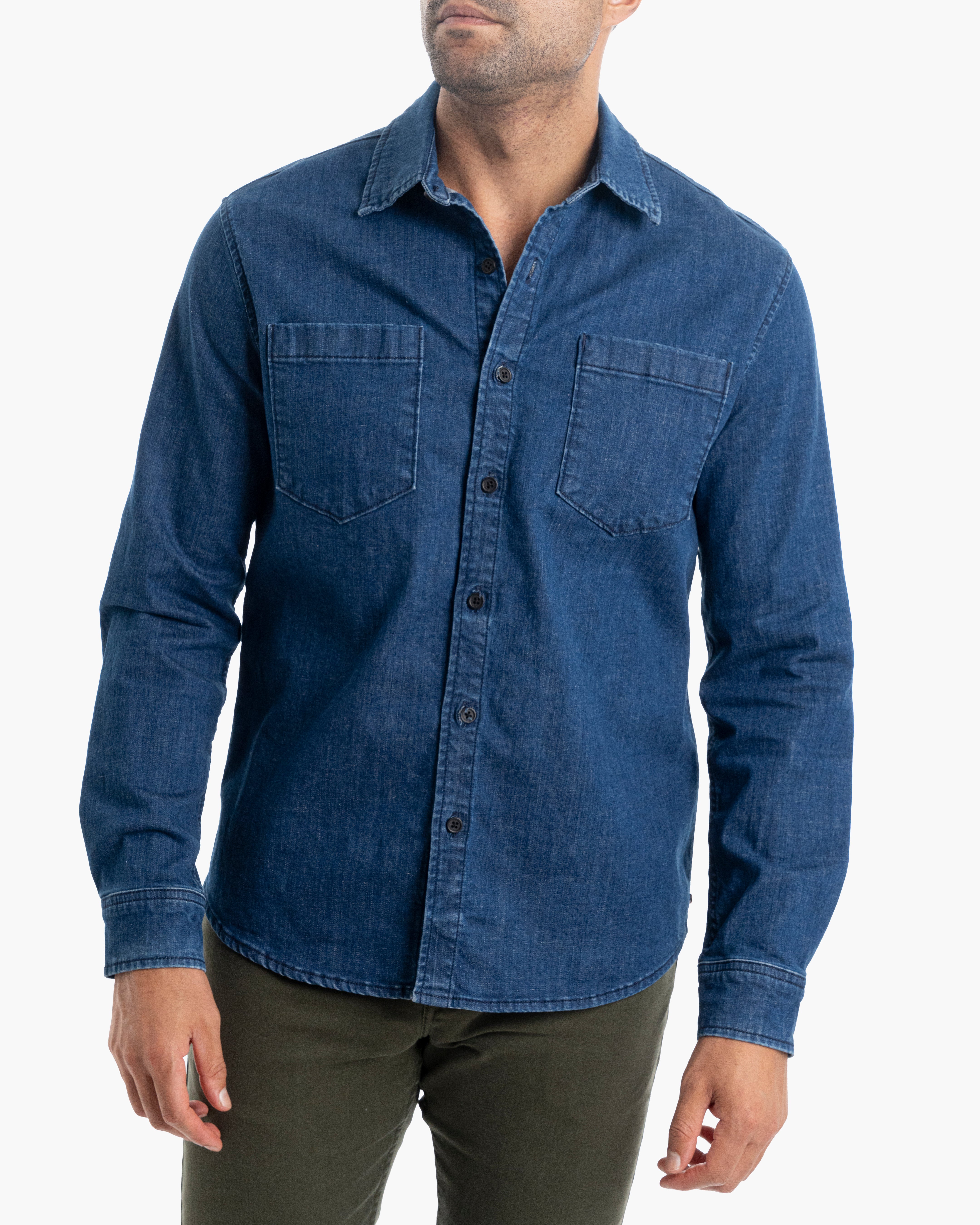 Model wearing a blue denim button-down shirt, Wyatts, with a casual fit.