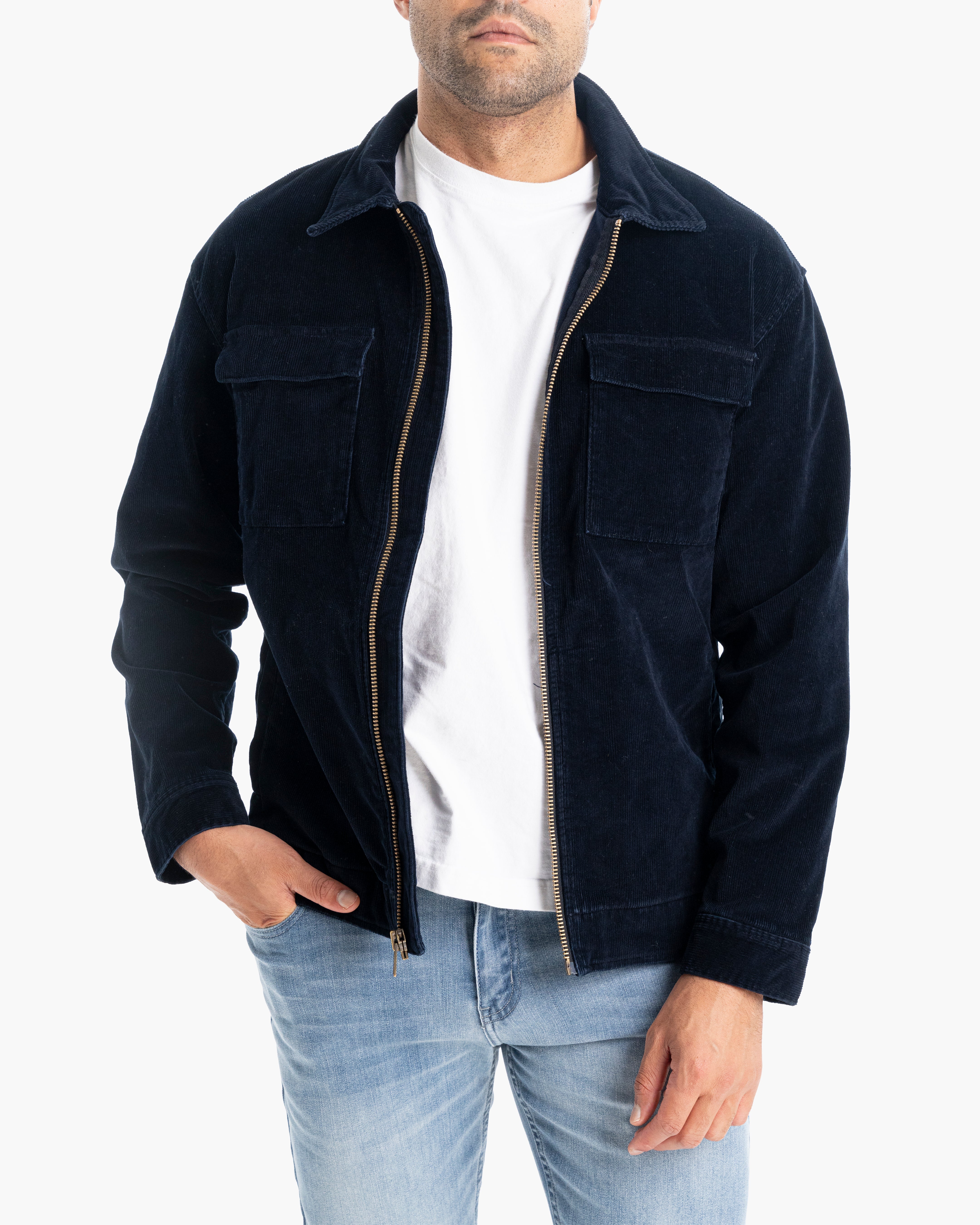 Model wearing a navy corduroy jacket with a zip front and pockets.