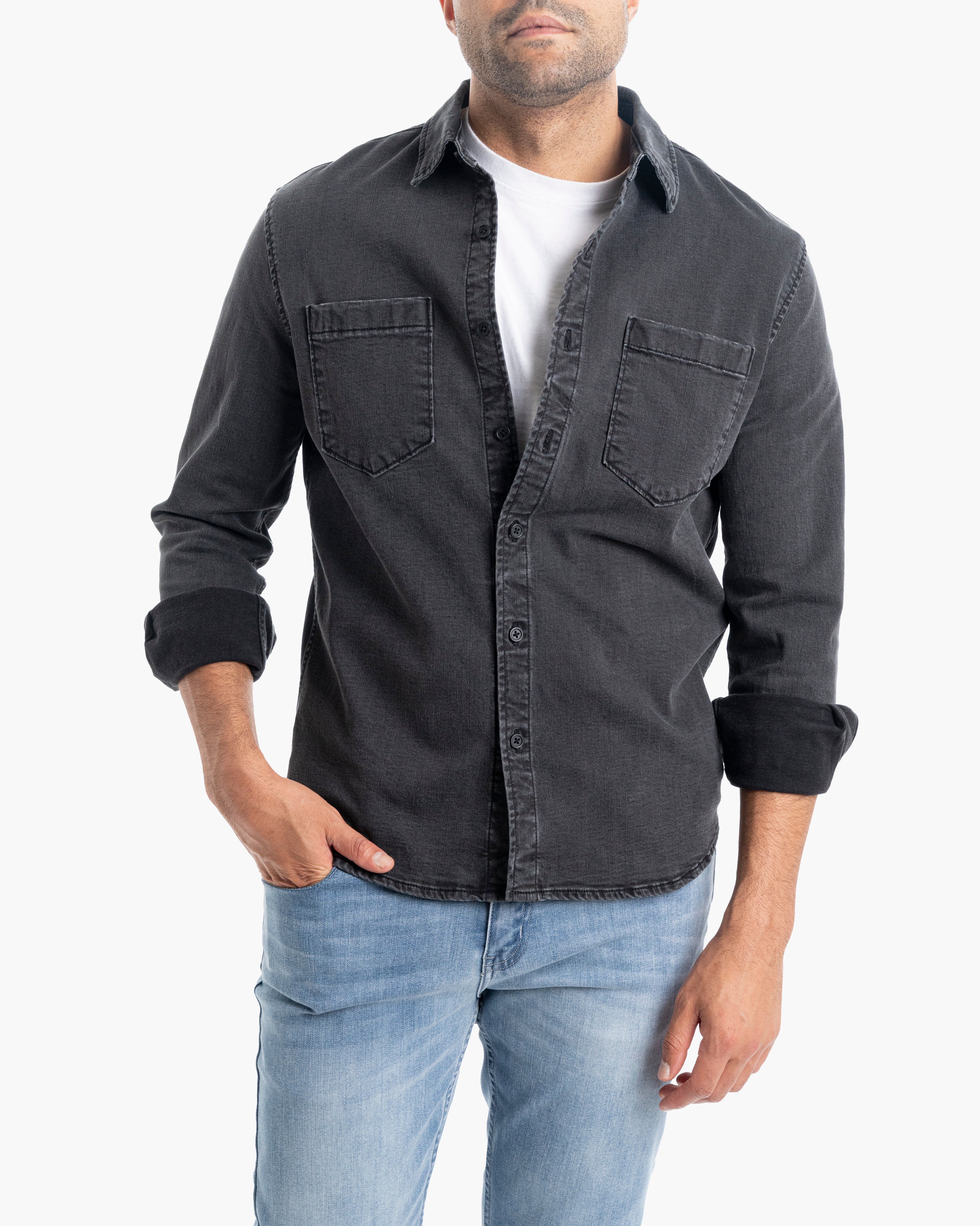 Model wearing a McCraes denim shirt in washed black, paired with jeans.