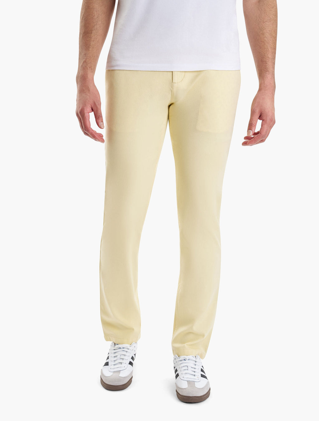 A person wearing yellow Marigolds chinos with white sneakers
