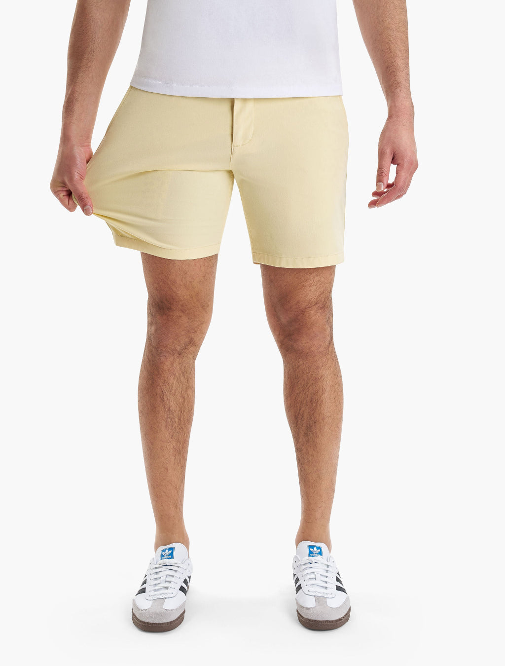 Model wearing yellow chino shorts, showcasing fit and style.