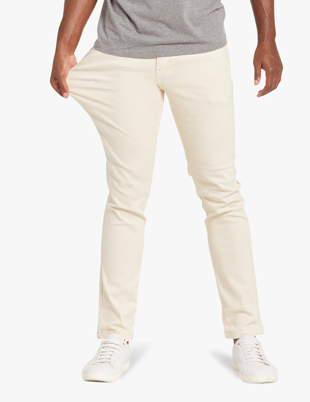 Cream colored jeans worn by a model, showcasing fit and style.