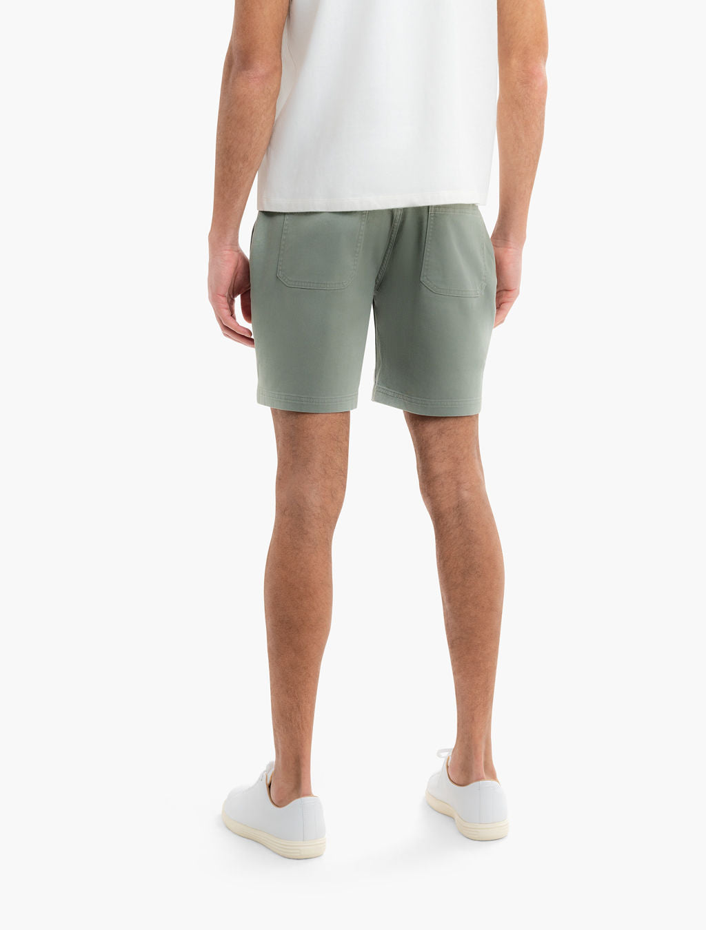 Back view of Twill Drawstring Shorts in seagrass showing patch back pockets and relaxed fit on model on white background