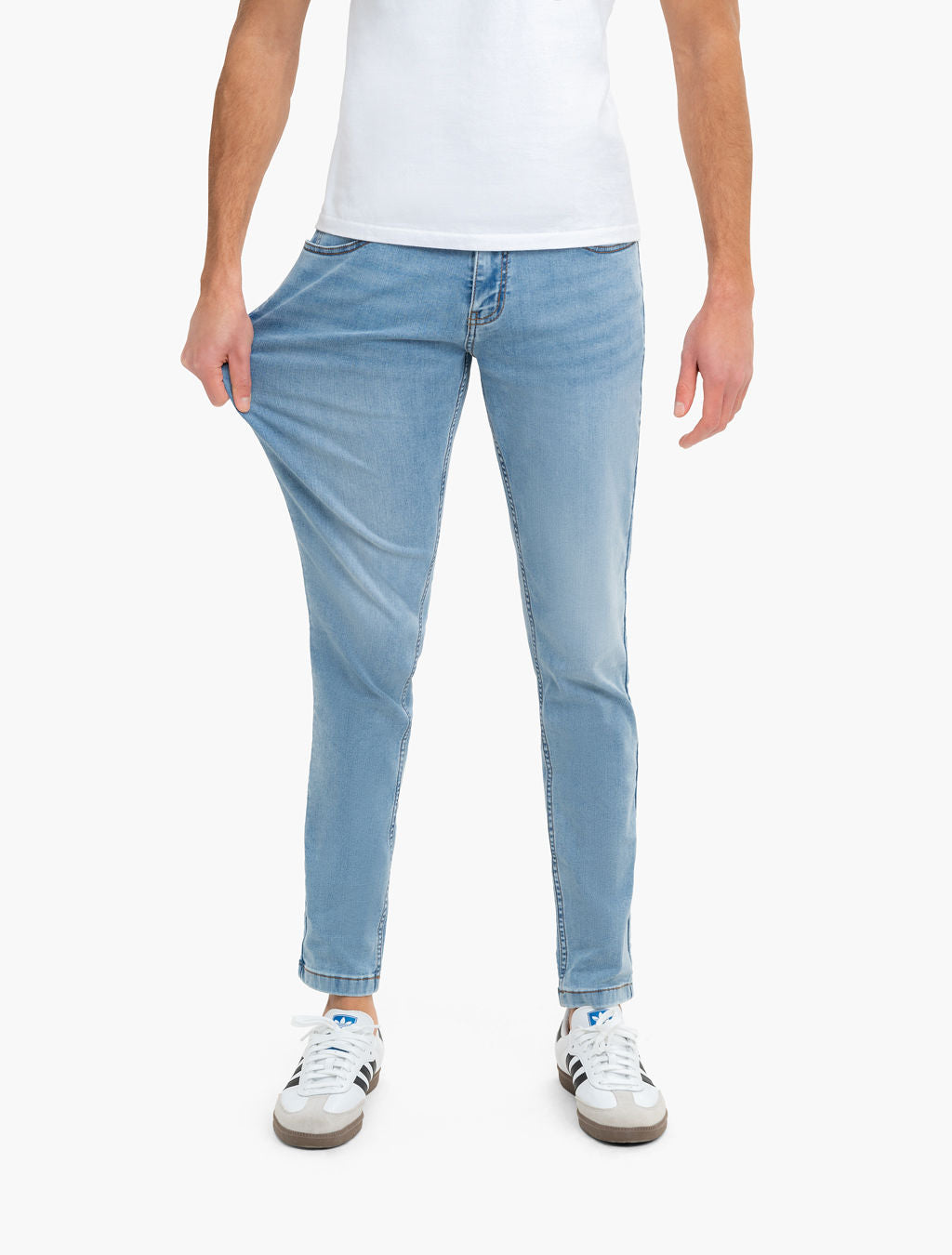 Front view of Daytonas Tapered jeans on model showing slim tapered fit in vintage washed light blue with white background