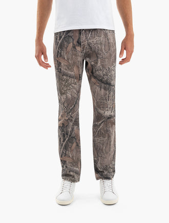 Men's straight-leg Realtree camo pants shown front view with white sneakers.