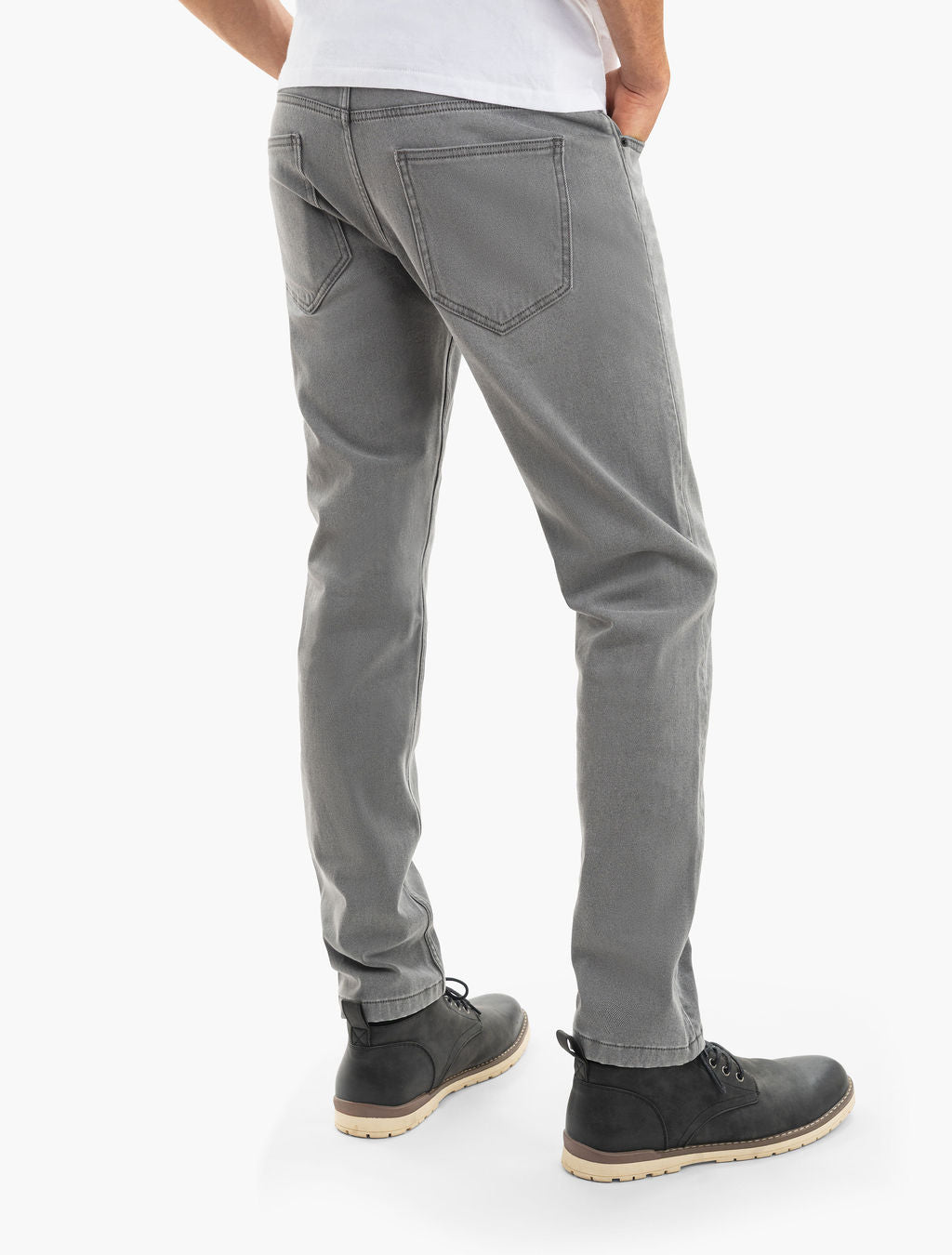 Men's gray jeans, back view showing rear pockets, straight fit, worn with black lace-up boots