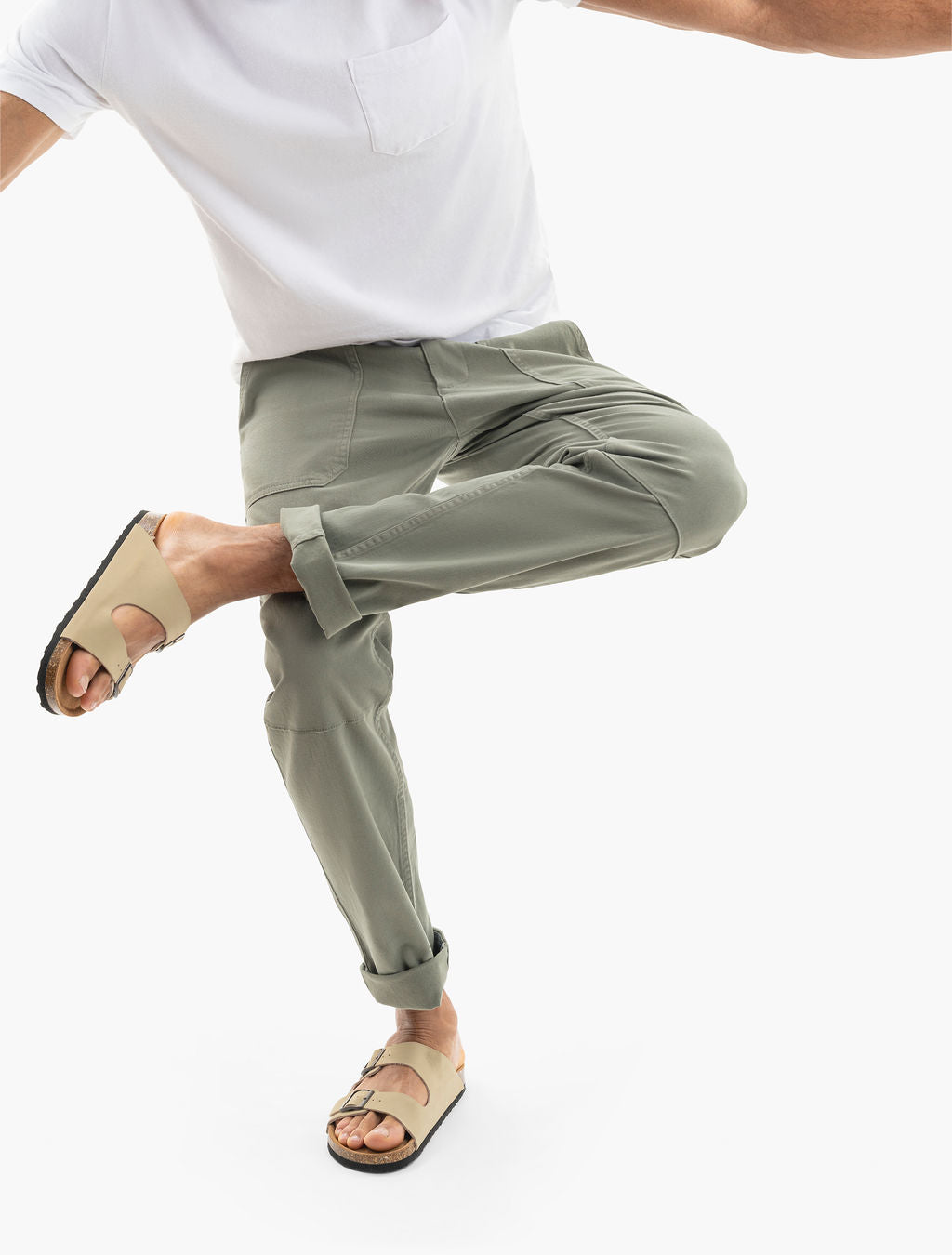 Three quarter front view of Seagrass twill drawstring pants showing tapered legs, patch pockets, and rolled cuffs on a model mid step