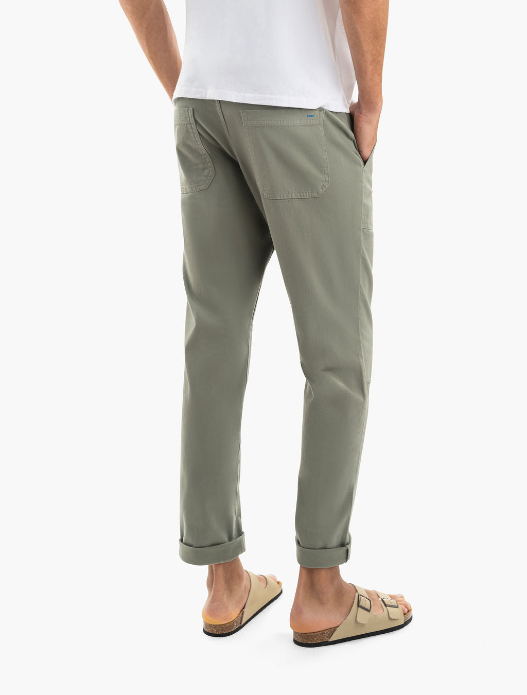 Back view of Seagrass twill patch-pocket pants showcasing rolled cuffs and rear patch pockets on a model against white background