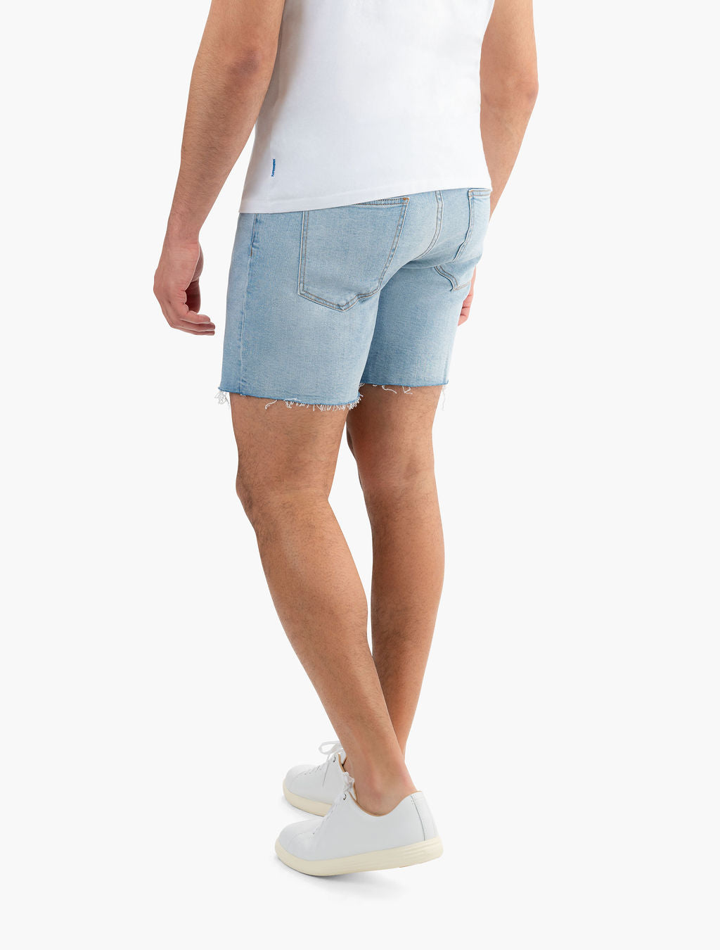Model wearing vintage blue stretch jorts from the back