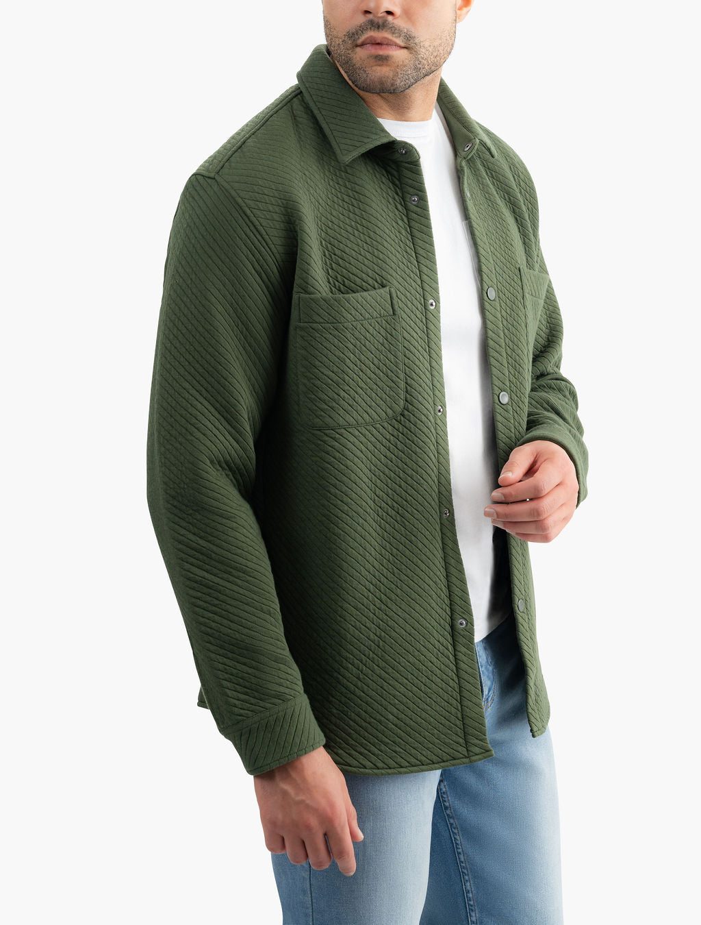 Three-quarter view of Diamond Knit Shacket in Huntsmans green showing diamond quilted texture, snap-front closure, chest pockets, relaxed fit