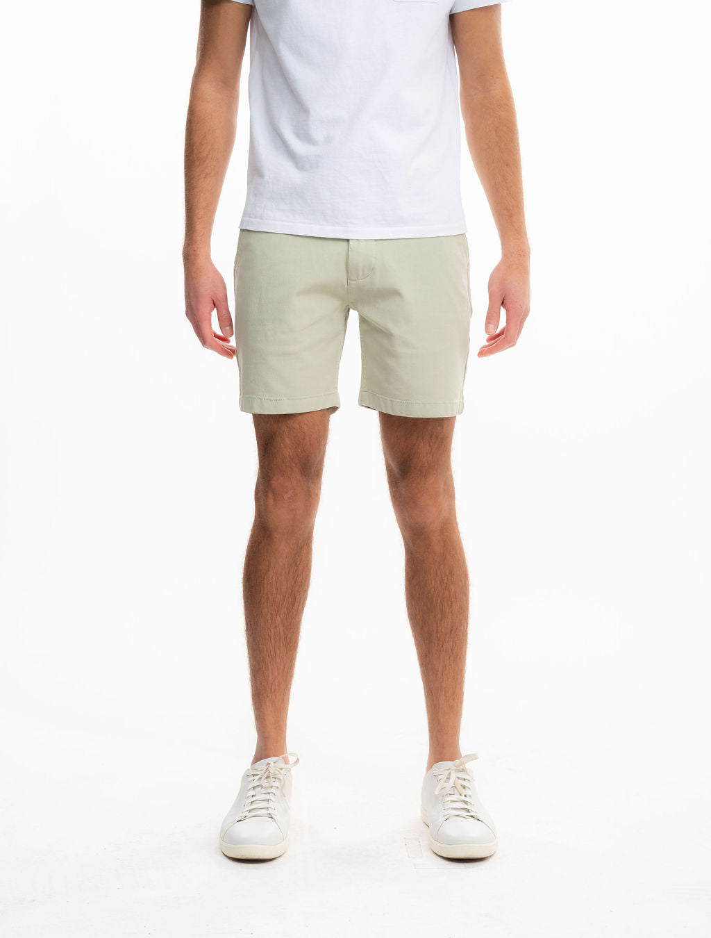 Front view of Willows chino shorts showcasing sage green color and mid-thigh relaxed fit on a model with white background