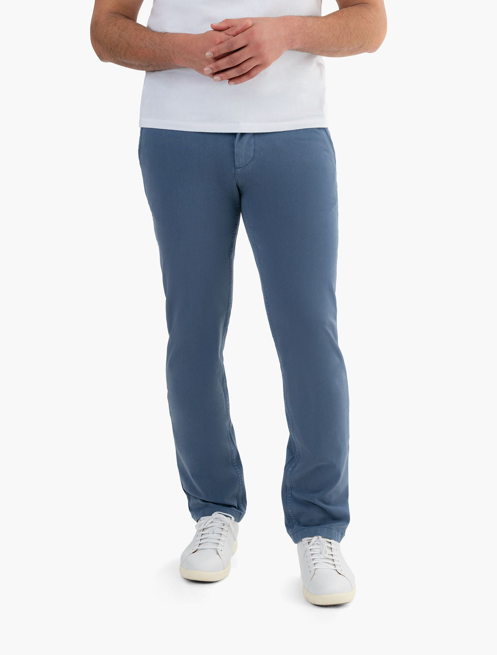 Front view of Classic Chinos in Saltwaters blue on model showing straight leg fit with white sneakers on white background