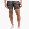 Front view of Realtree Edge camo cut-off shorts on model showing frayed hem and mid-thigh length on white background