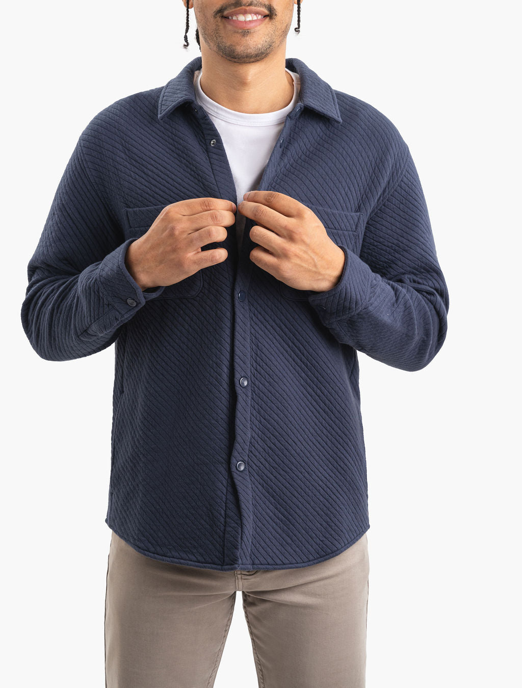 Model wearing a closed navy Mariners quilted shacket, front view.