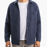 Model wearing a navy Mariners quilted shacket, front view.