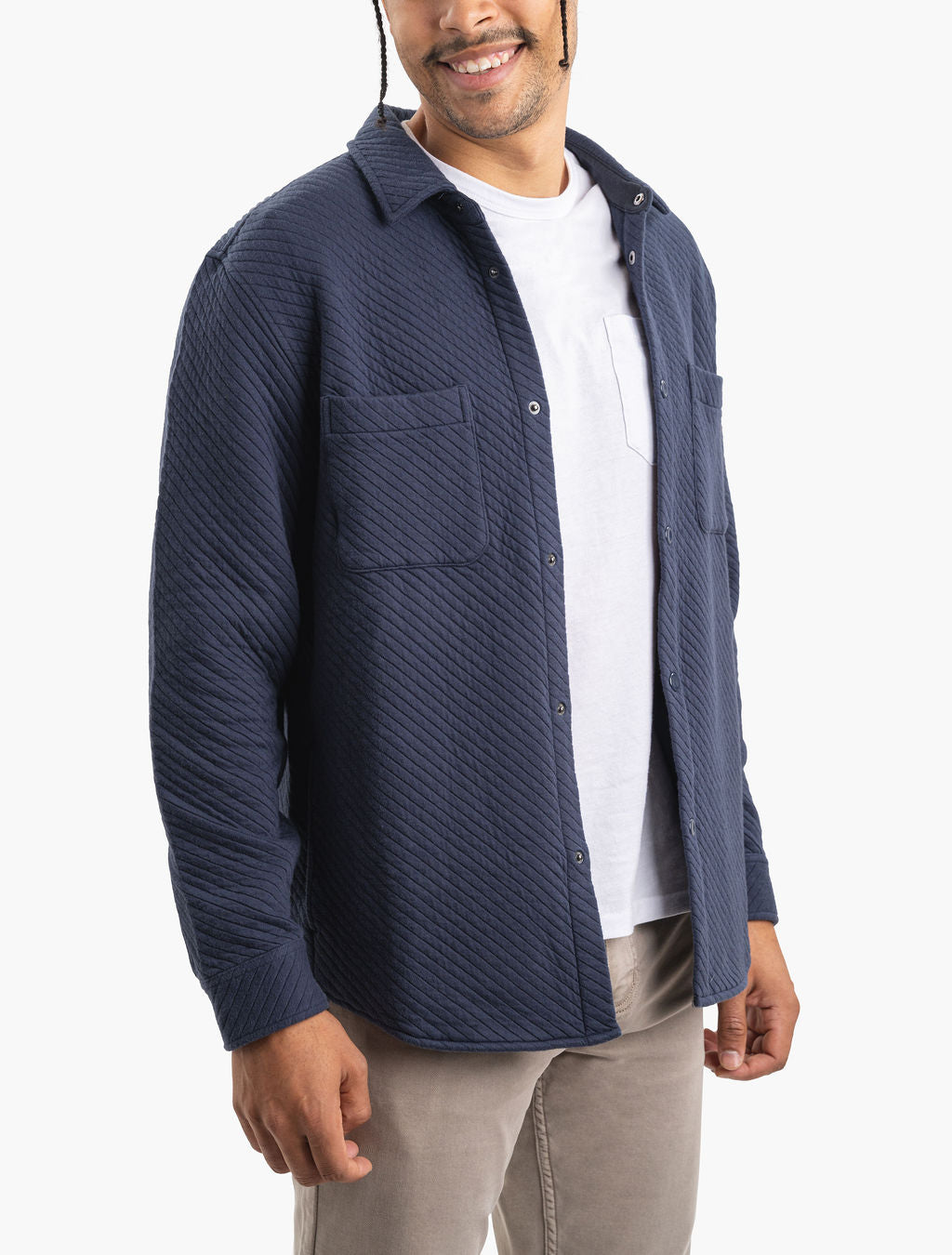 Three-quarter view of navy Diamond Knit Shacket with diagonal quilted texture, snap front and chest pockets on white