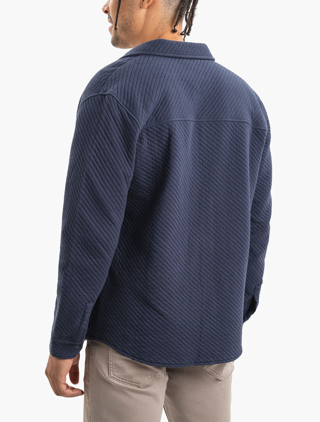 Model wearing a navy Mariners quilted shacket, backwards.