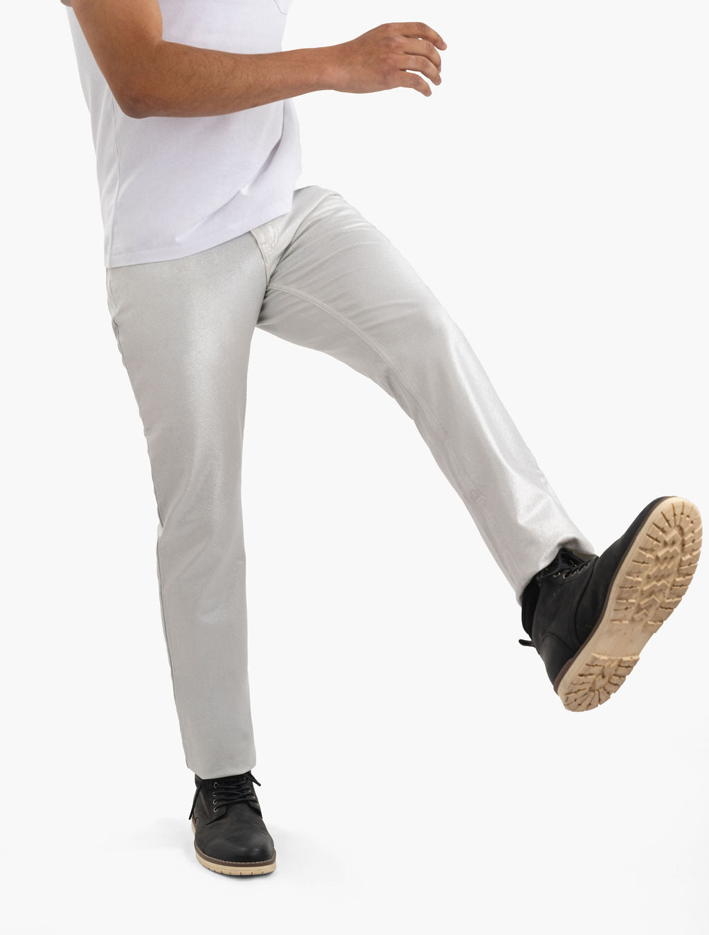 Person wearing metallic silver pants and black lace-up boots, right leg lifted mid-step
