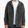 Man wearing charcoal corduroy button-front shirt with hood over white T-shirt, shown from shoulders to hips.