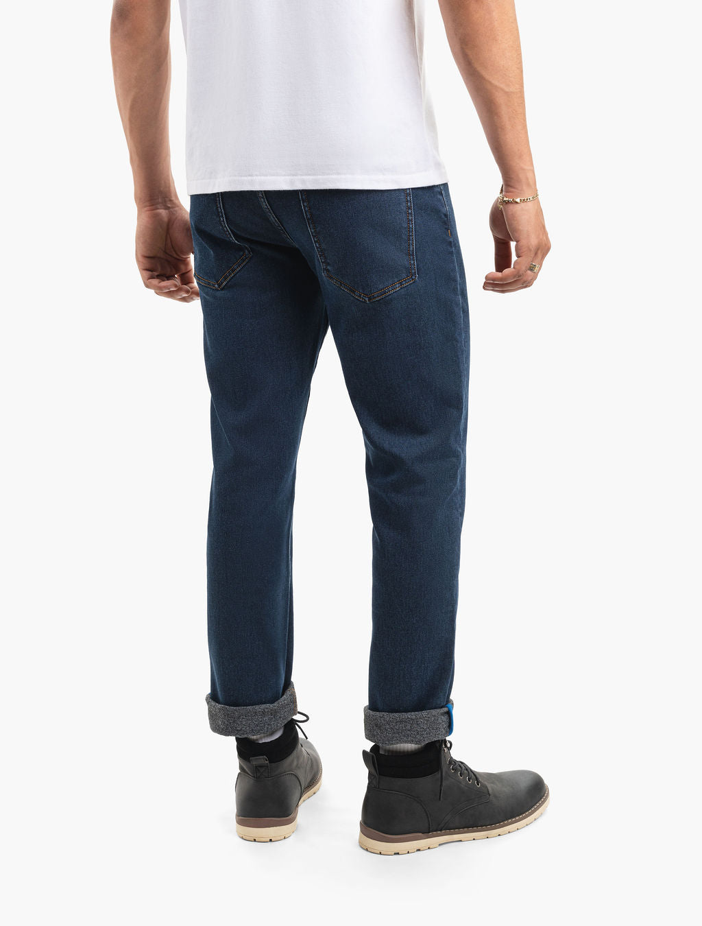 Back view of Boilers dark indigo cuffed straight-leg jeans showing rear pockets and rolled cuffs with black lace-up boots on white background