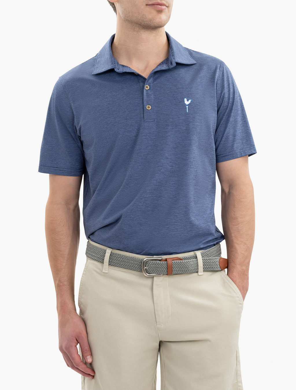 Man wearing a blue striped polo shirt with a small white logo on the chest and beige pants with a woven belt