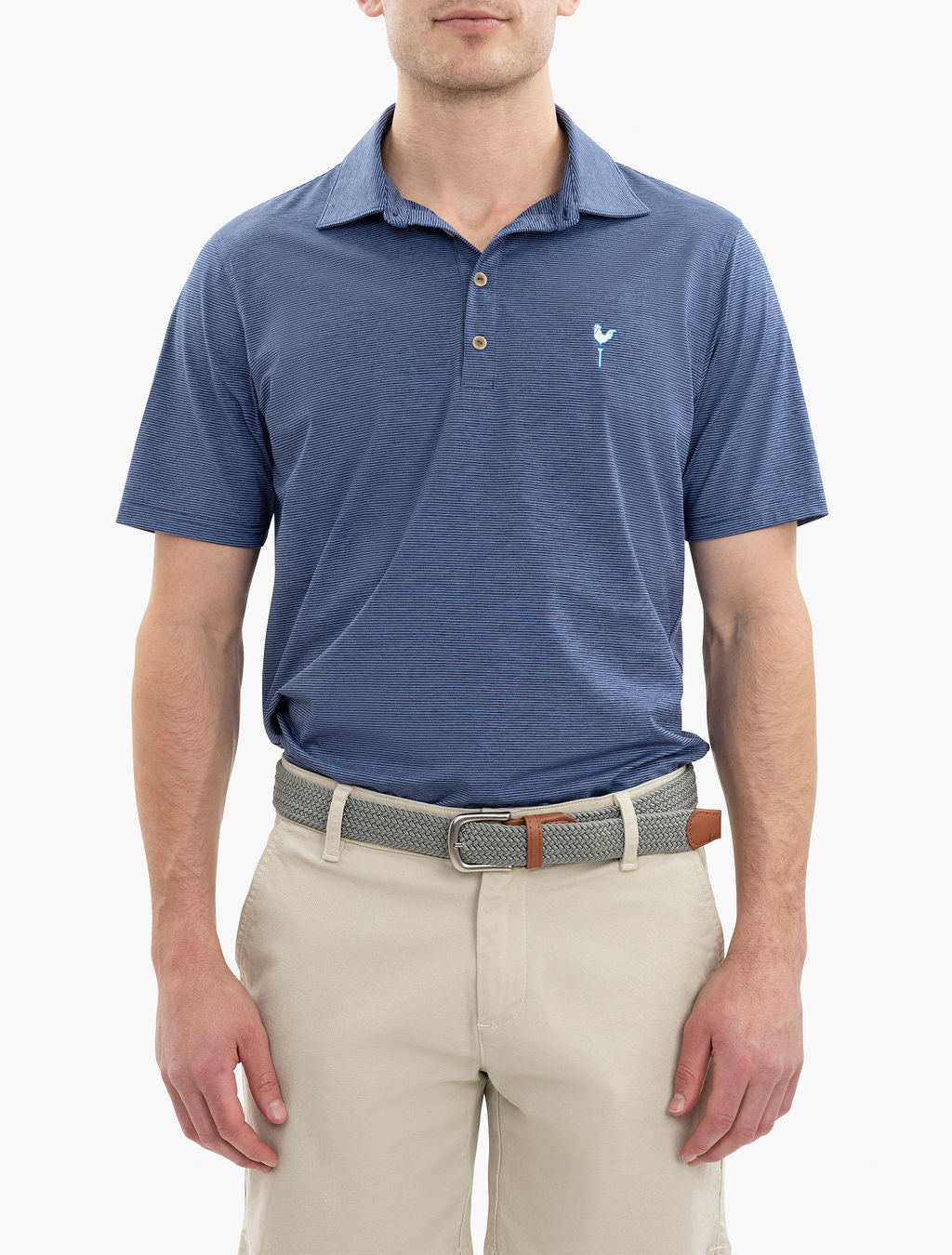 Man wearing a blue short-sleeve polo shirt with a small bird logo on the chest and beige shorts with a woven belt